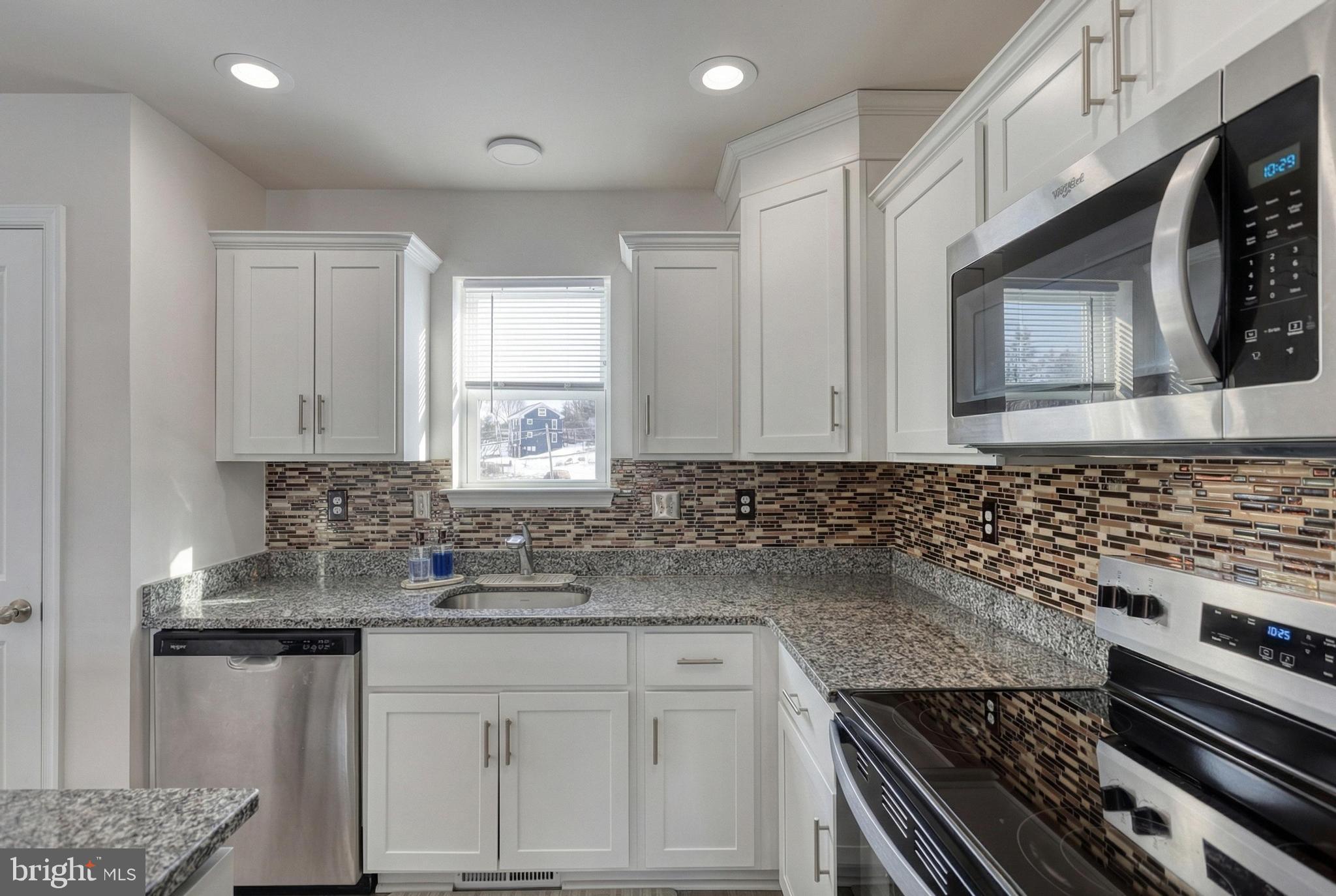 1 Landing Place, Unit 1 York, PA 17408 - Photo 13 of 48 a kitchen with granite countertop a stove sink and cabinets