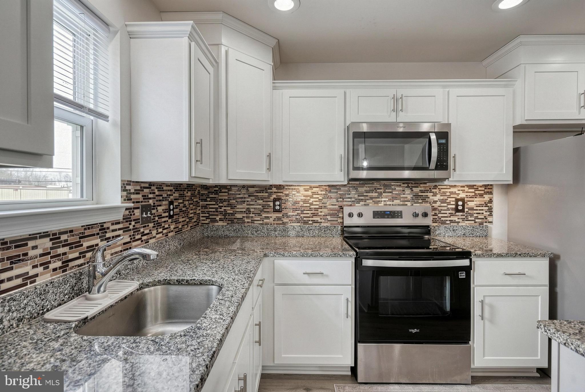 1 Landing Place, Unit 1 York, PA 17408 - Photo 14 of 48 a kitchen with granite countertop a sink stove and microwave