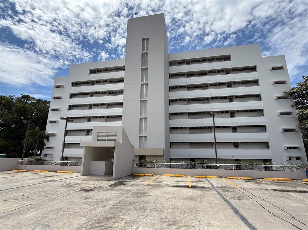 Condo Pelican Reef Condo Pelican Reef, Unit 302 Rincon, PR 00677 - Photo 2 of 16 a view of a building with wooden fence