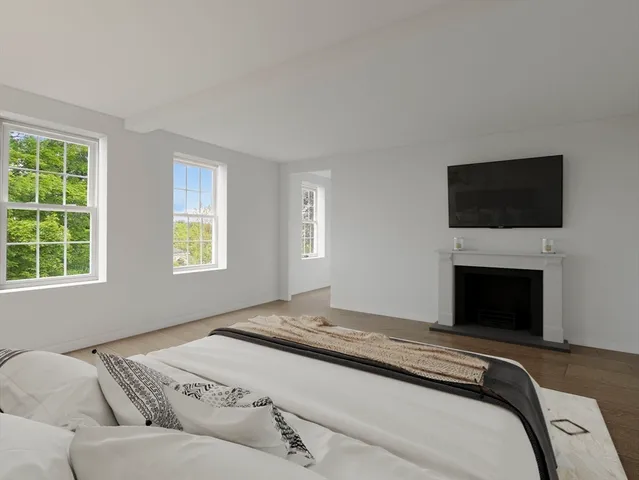 a bedroom with a bed and a television