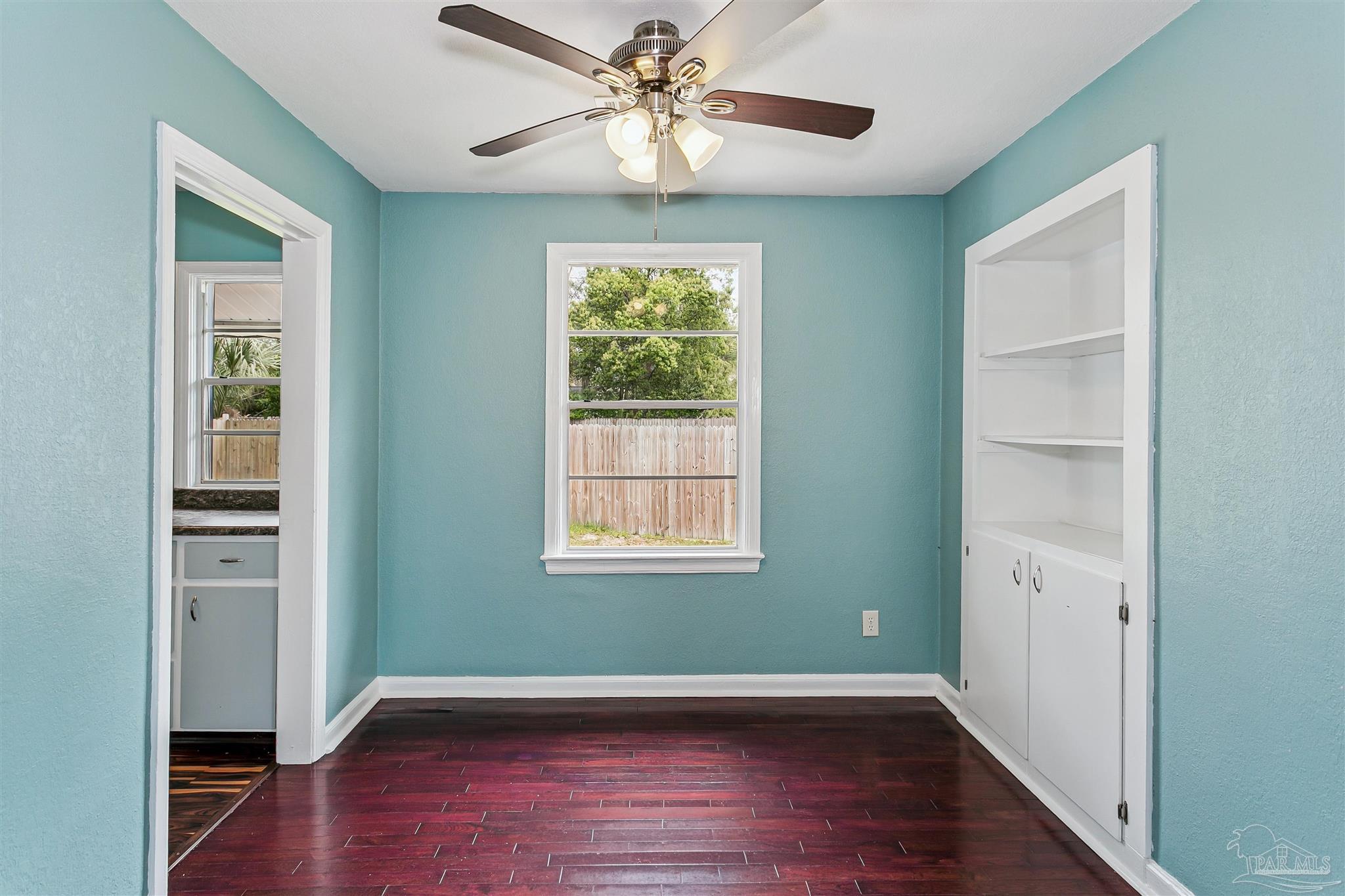 100 Milton Road Pensacola, FL 32507 - Photo 14 of 28 wooden floor in an empty room with a window