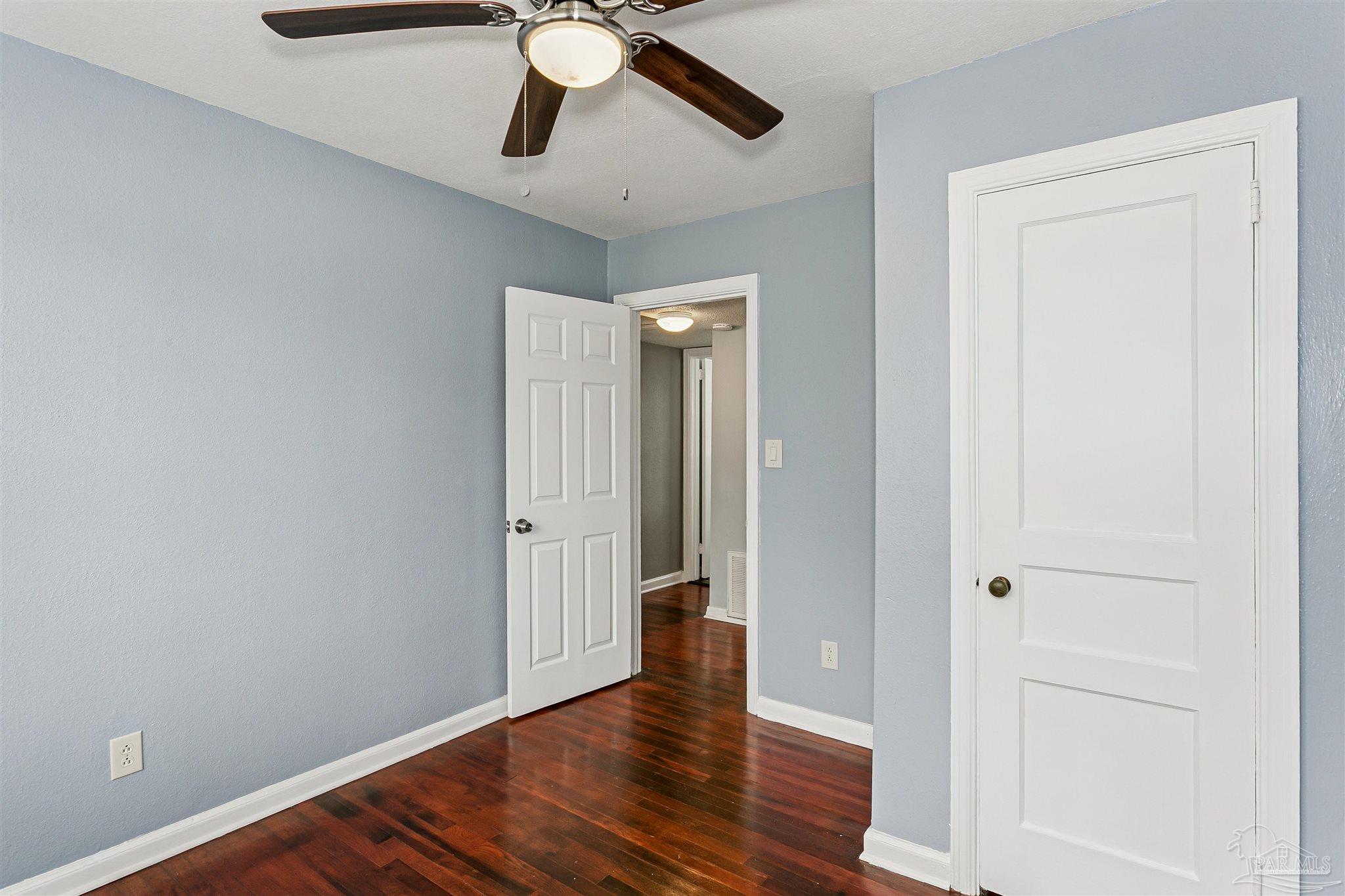 100 Milton Road Pensacola, FL 32507 - Photo 16 of 28 wooden floor in an empty room with a window