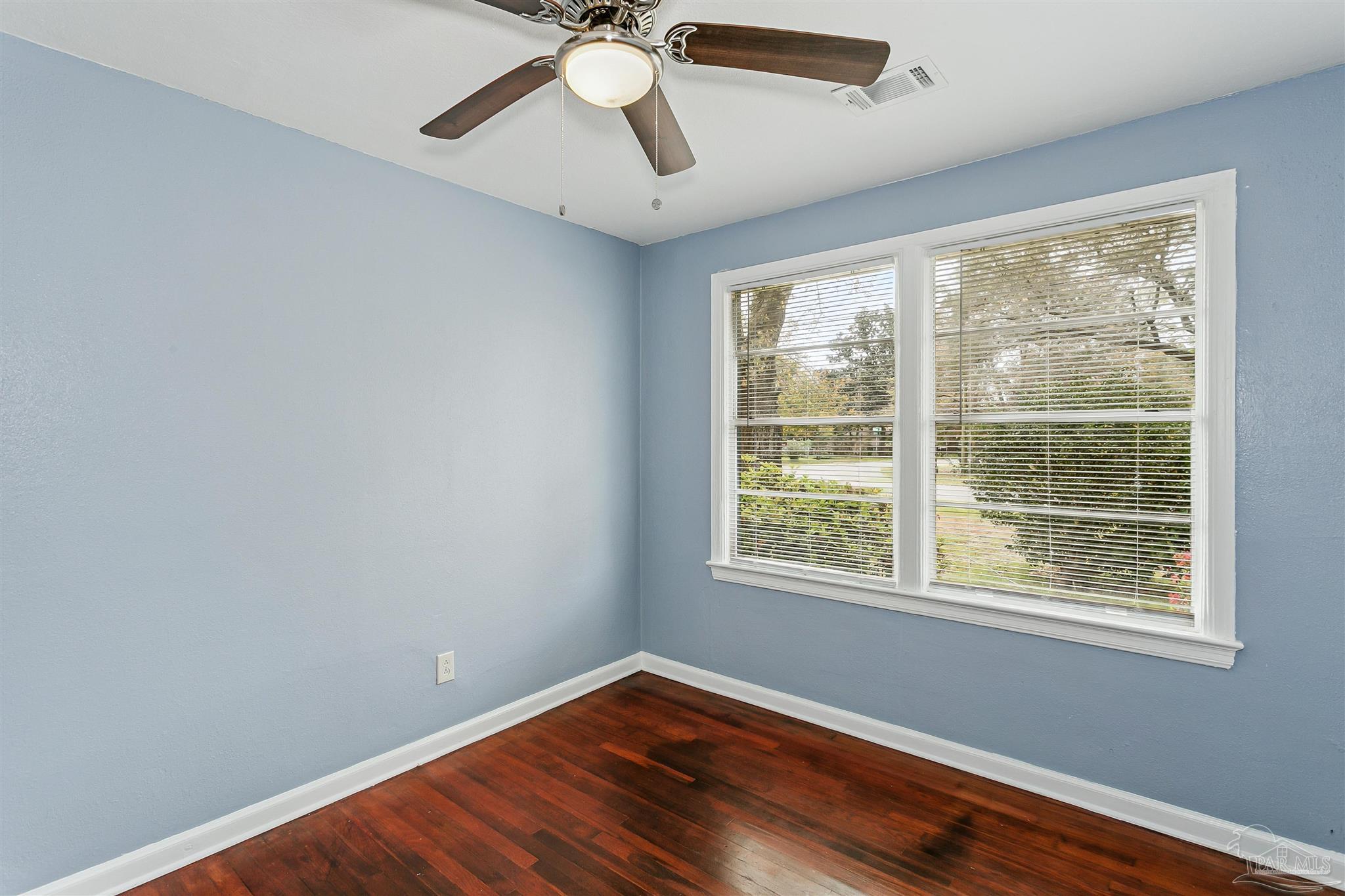 100 Milton Road Pensacola, FL 32507 - Photo 17 of 28 a view of an empty room with wooden floor and a window