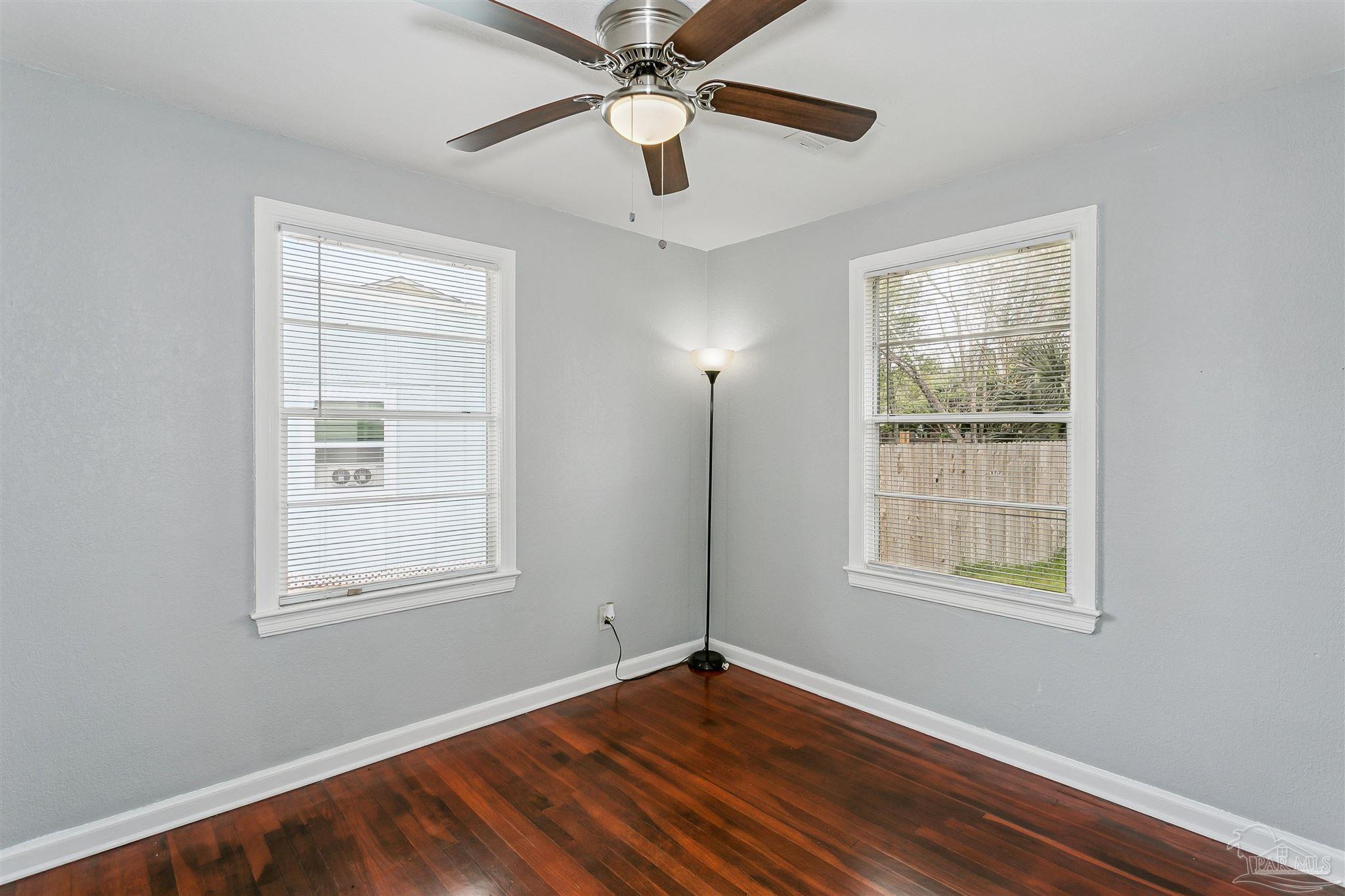 100 Milton Road Pensacola, FL 32507 - Photo 20 of 28 a view of an empty room with wooden floor and a window