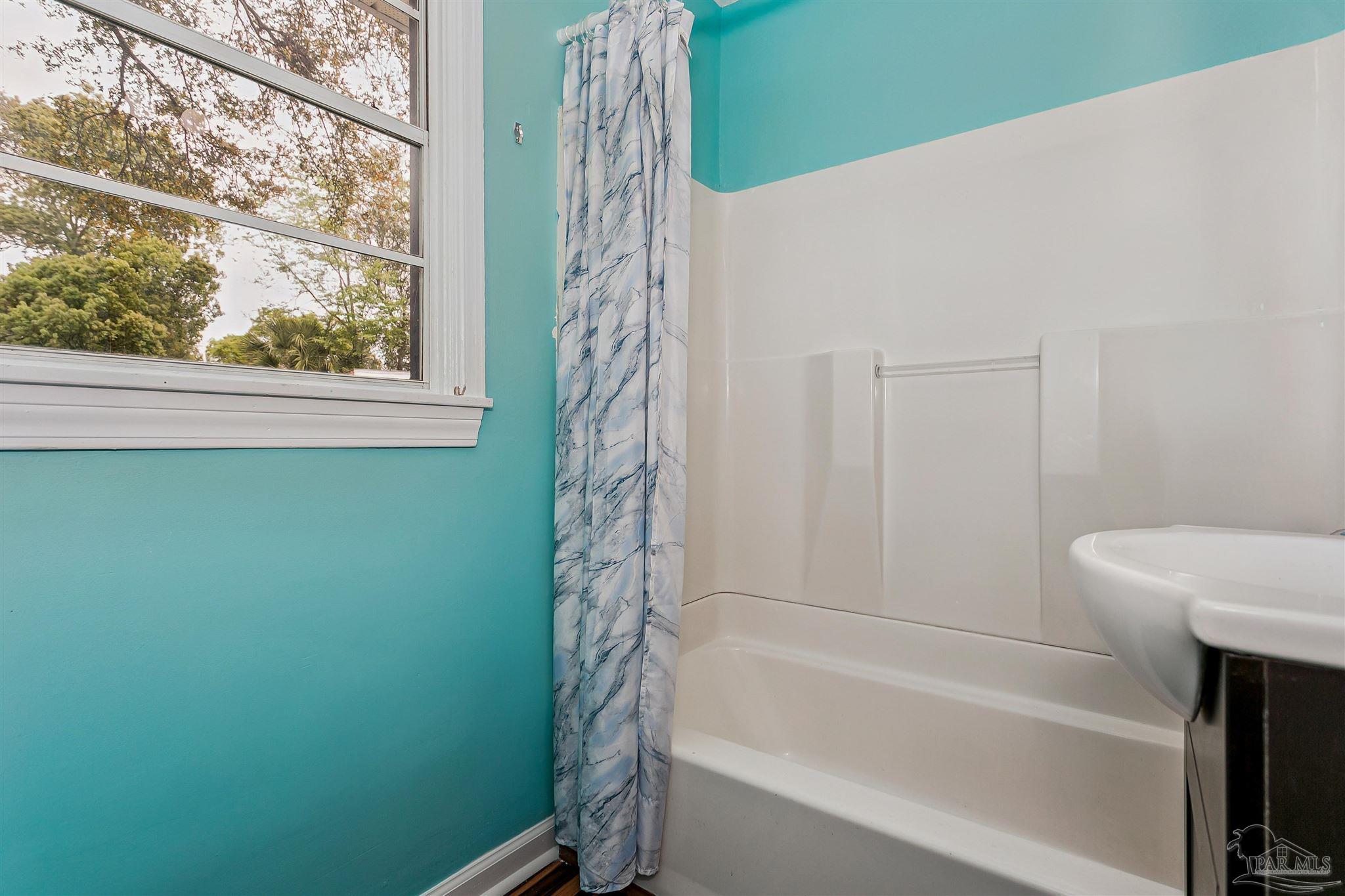 100 Milton Road Pensacola, FL 32507 - Photo 23 of 28 a bathroom with a bathtub and shower