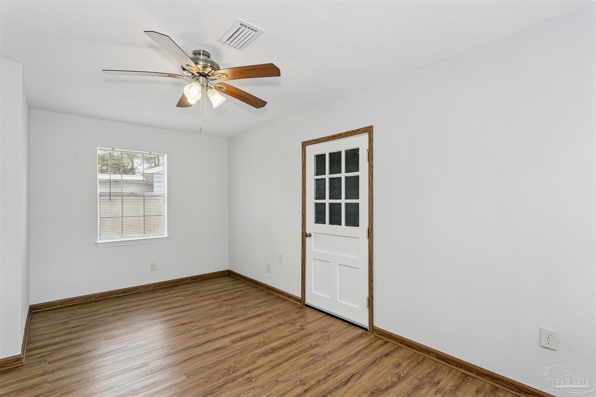 100 Milton Road Pensacola, FL 32507 - Photo 24 of 28 a view of empty room with wooden floor and fan