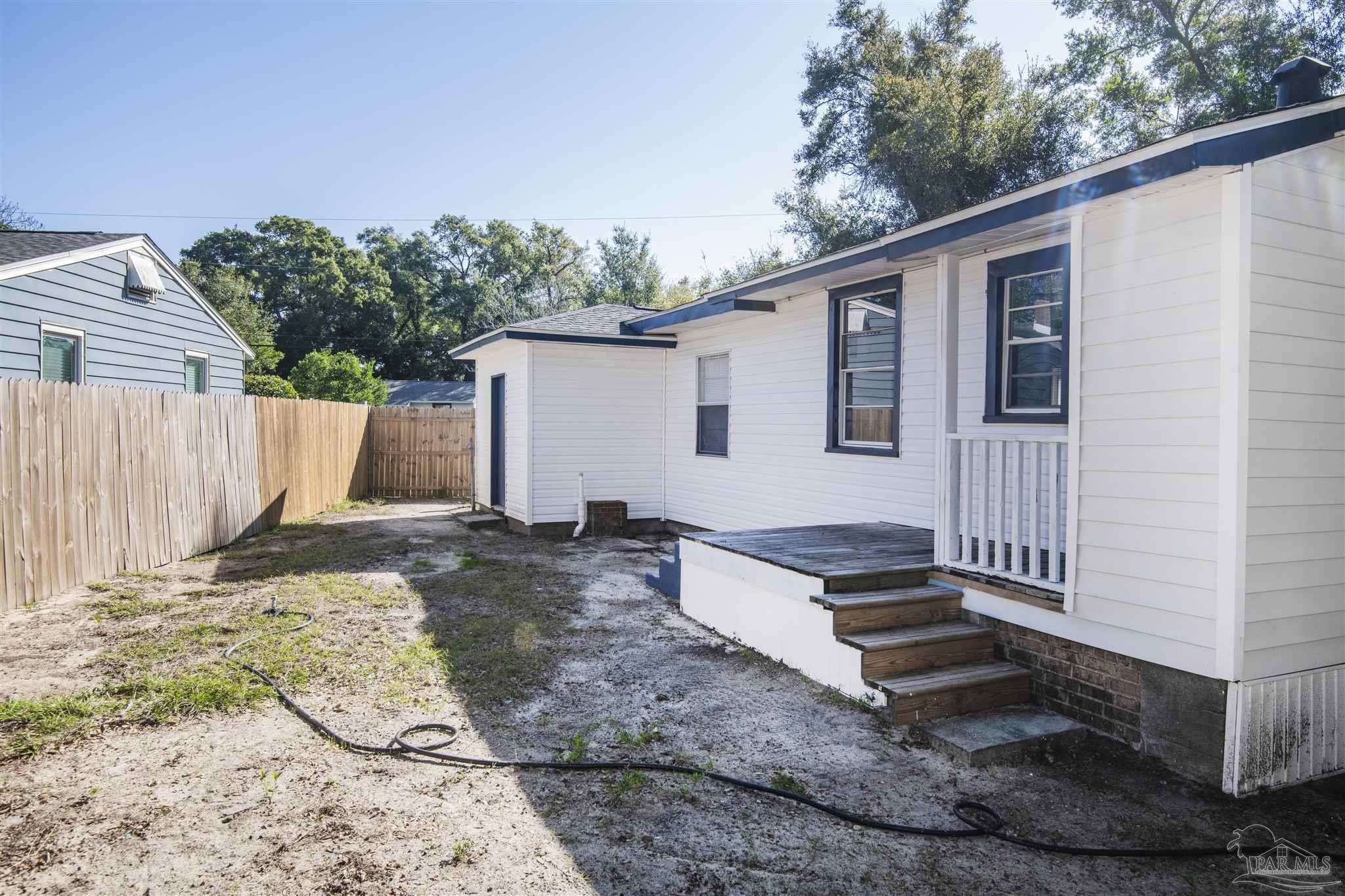 100 Milton Road Pensacola, FL 32507 - Photo 26 of 28 a backyard of a house with wooden floor barbeque oven and yard