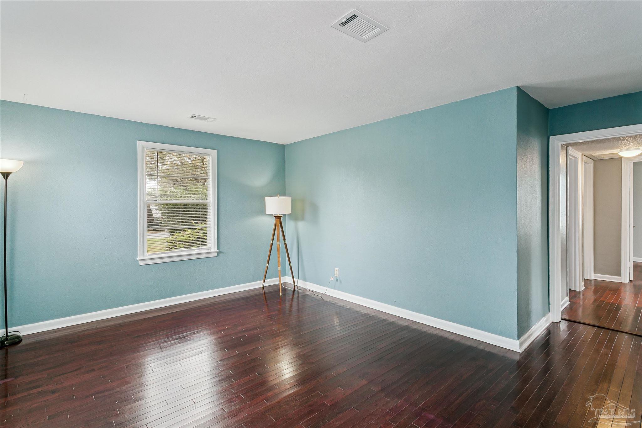 100 Milton Road Pensacola, FL 32507 - Photo 9 of 28 a view of empty room with wooden floor and fan