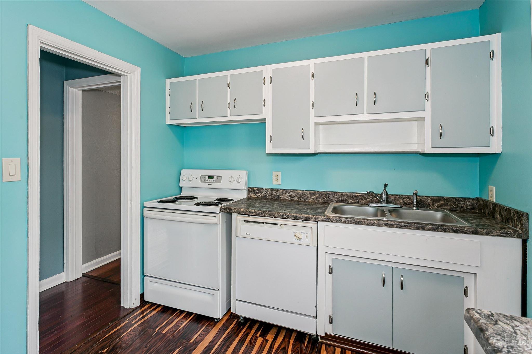 100 Milton Road Pensacola, FL 32507 - Photo 10 of 28 a kitchen with granite countertop cabinets and white appliances