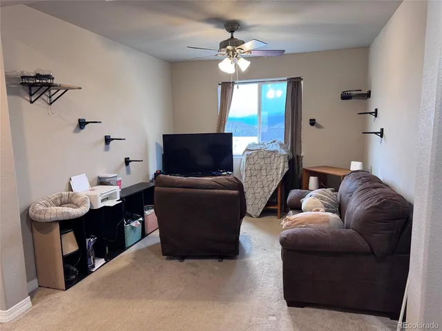 a living room with furniture a chandelier and a window