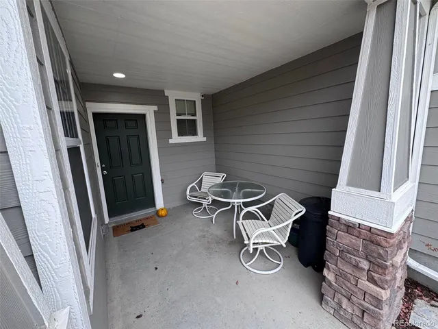 a view of a door and chair in the balcony