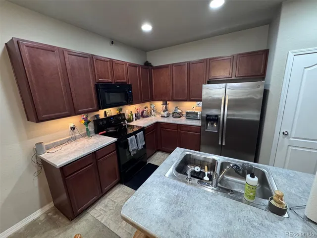 a kitchen with kitchen island a counter space and cabinets