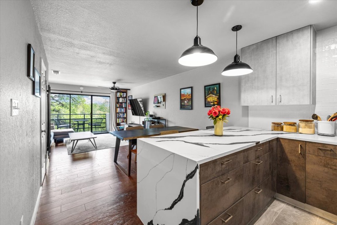 a kitchen that has a lot of cabinets a sink and a stove in it
