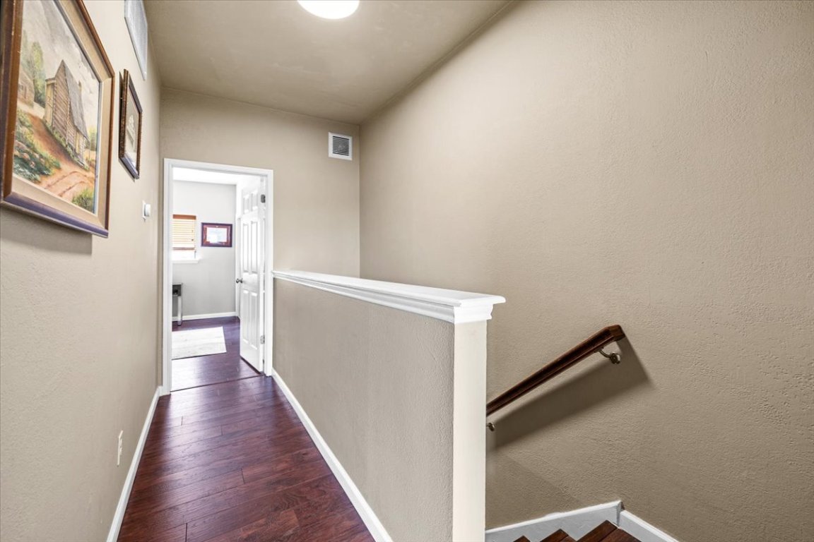 2605 Enfield Road, Unit 209 Austin, TX 78703 - Photo 18 of 29 a view of a hallway with wooden floor and staircase