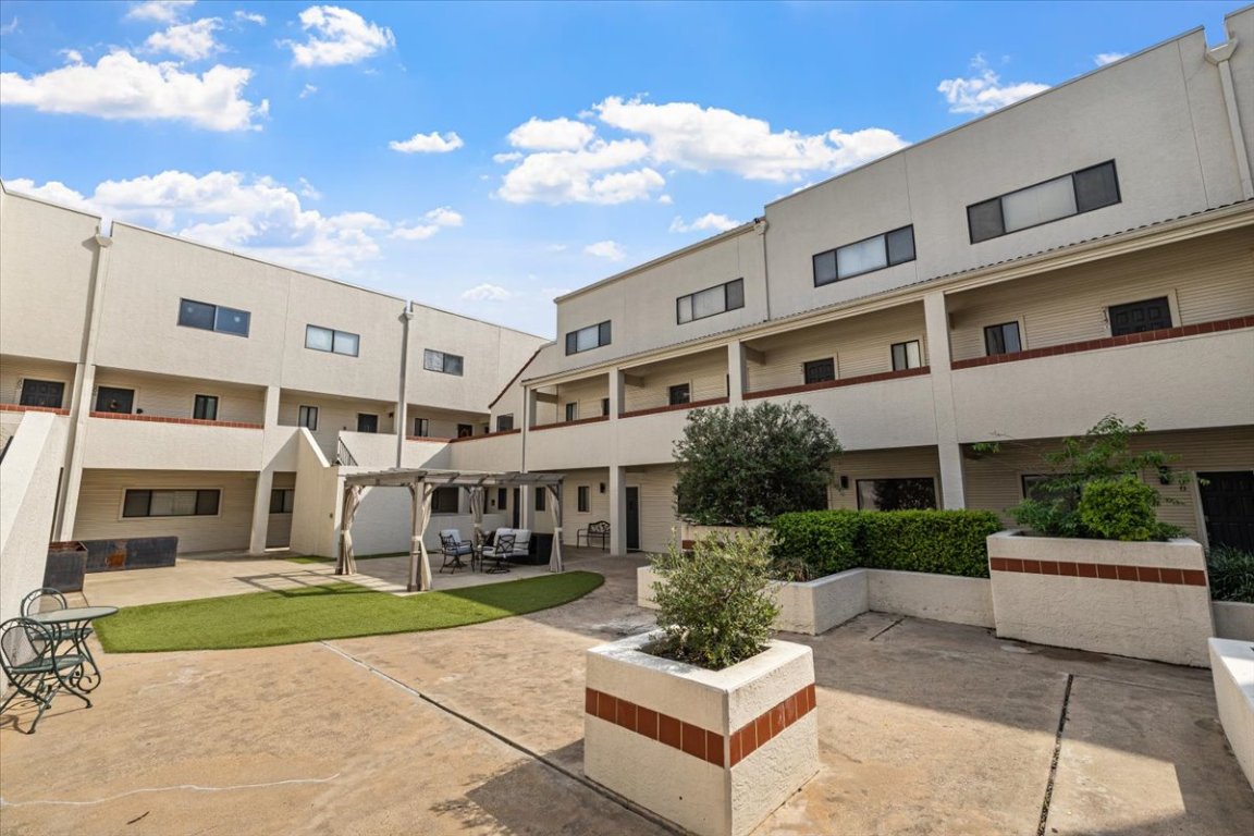2605 Enfield Road, Unit 209 Austin, TX 78703 - Photo 2 of 29 a view of an house with backyard and sitting area