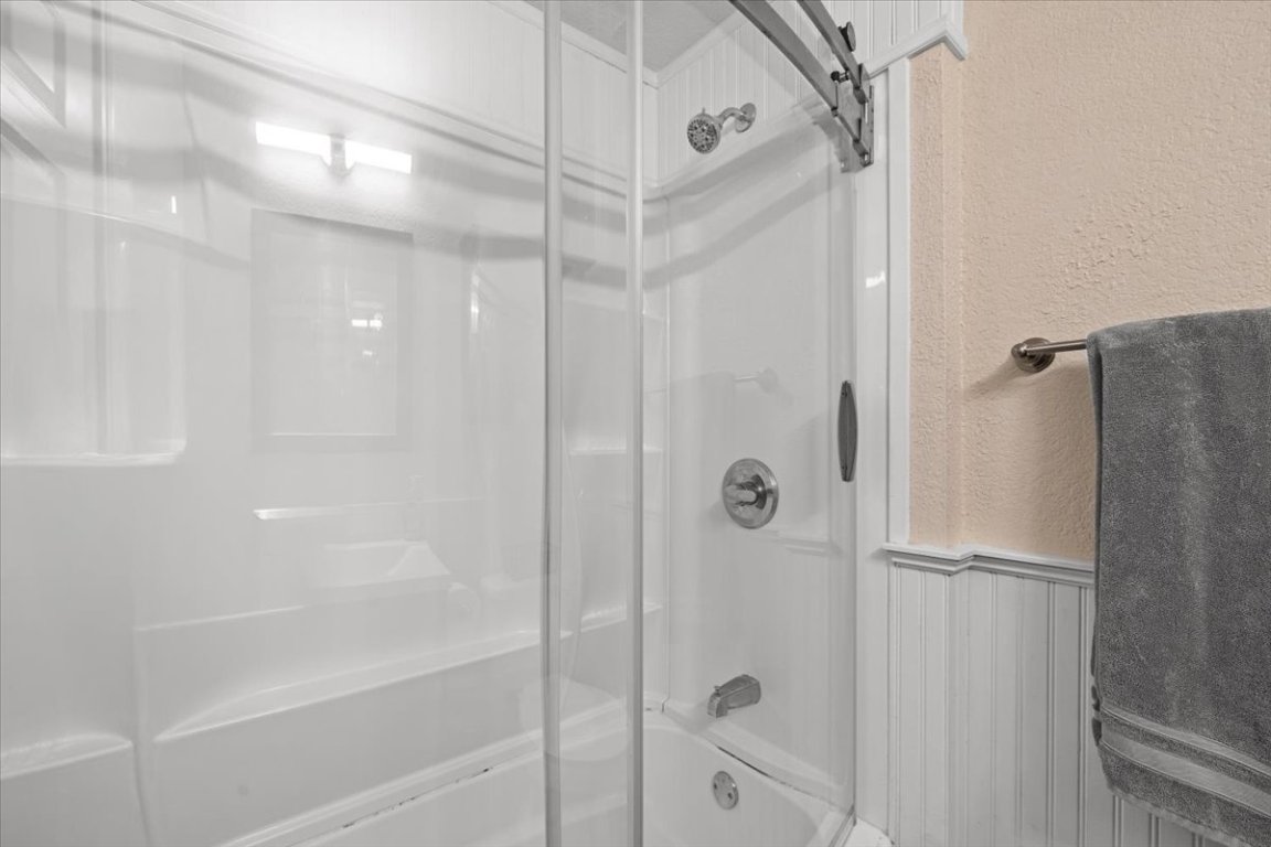 2605 Enfield Road, Unit 209 Austin, TX 78703 - Photo 25 of 29 a bathroom with a shower and a glass door