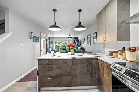 a kitchen with a sink a stove and a wooden floors