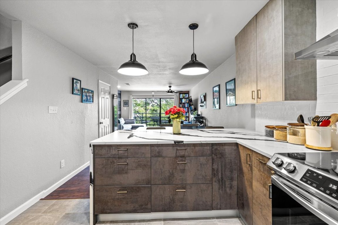 2605 Enfield Road, Unit 209 Austin, TX 78703 - Photo 7 of 29 a kitchen with a sink a stove and a wooden floors