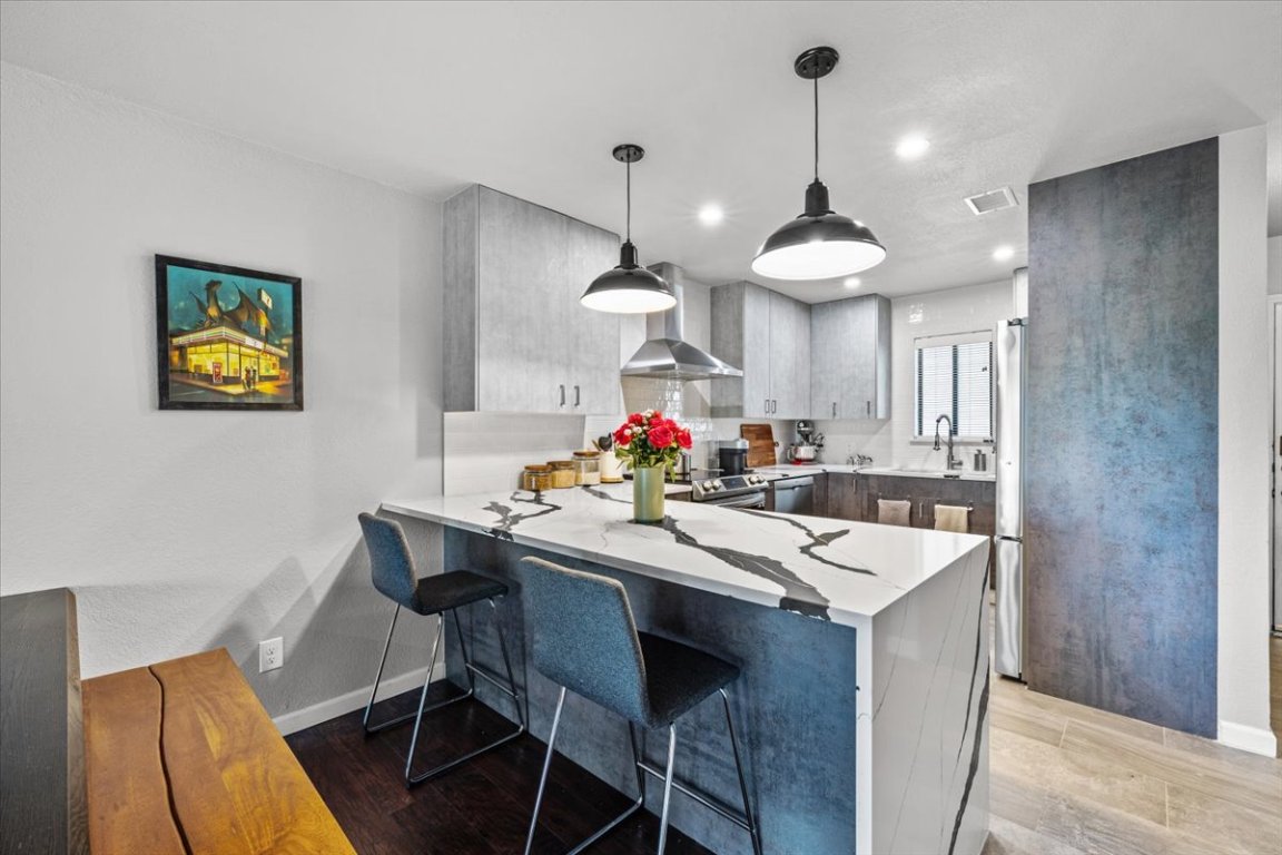 2605 Enfield Road, Unit 209 Austin, TX 78703 - Photo 9 of 29 a view of a dining room and chandelier furniture and wooden floor
