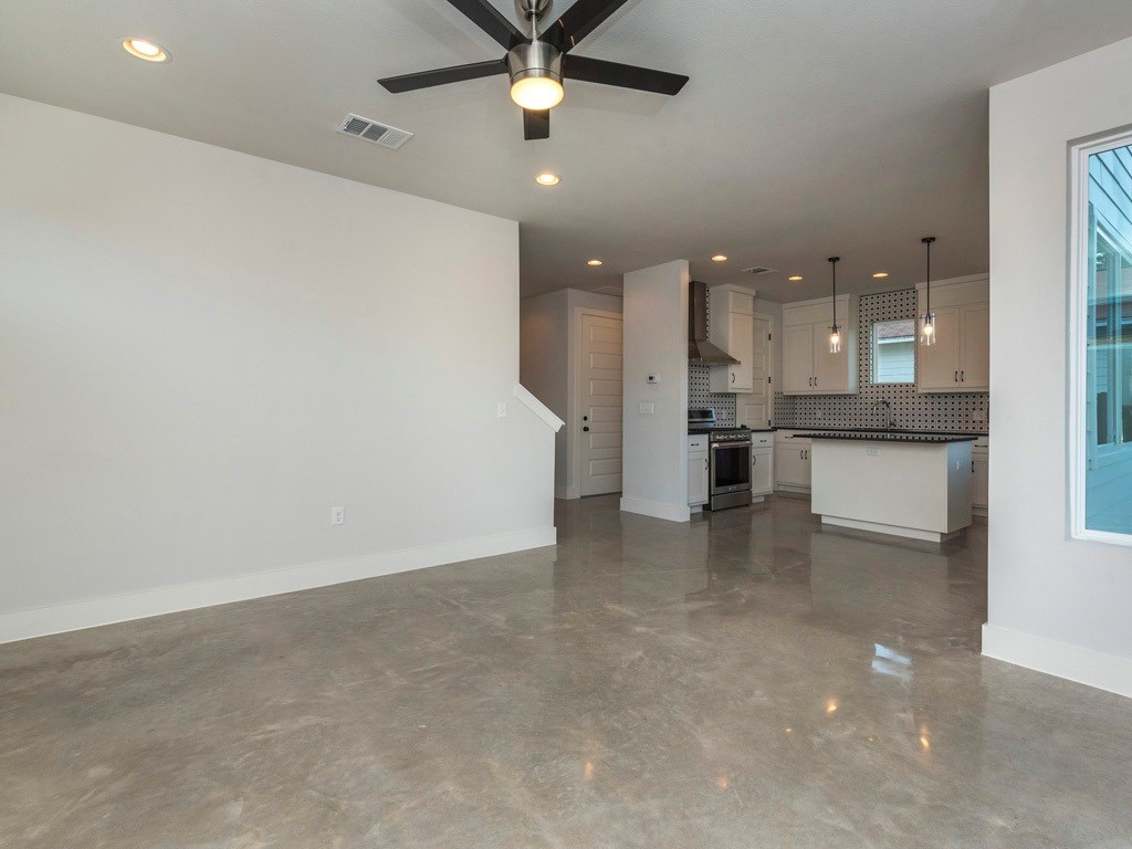 1182 Ridgeway Drive, Unit A Austin, TX 78702 - Photo 7 of 27 Unfurnished living room featuring ceiling fan and recessed lighting