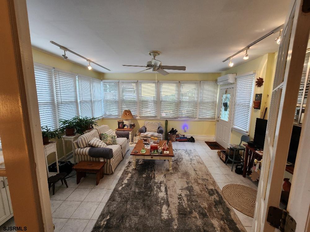 63 Cranford Road Turnersville, NJ 08012 - Photo 22 of 35 a living room with furniture a large window and gym equipment