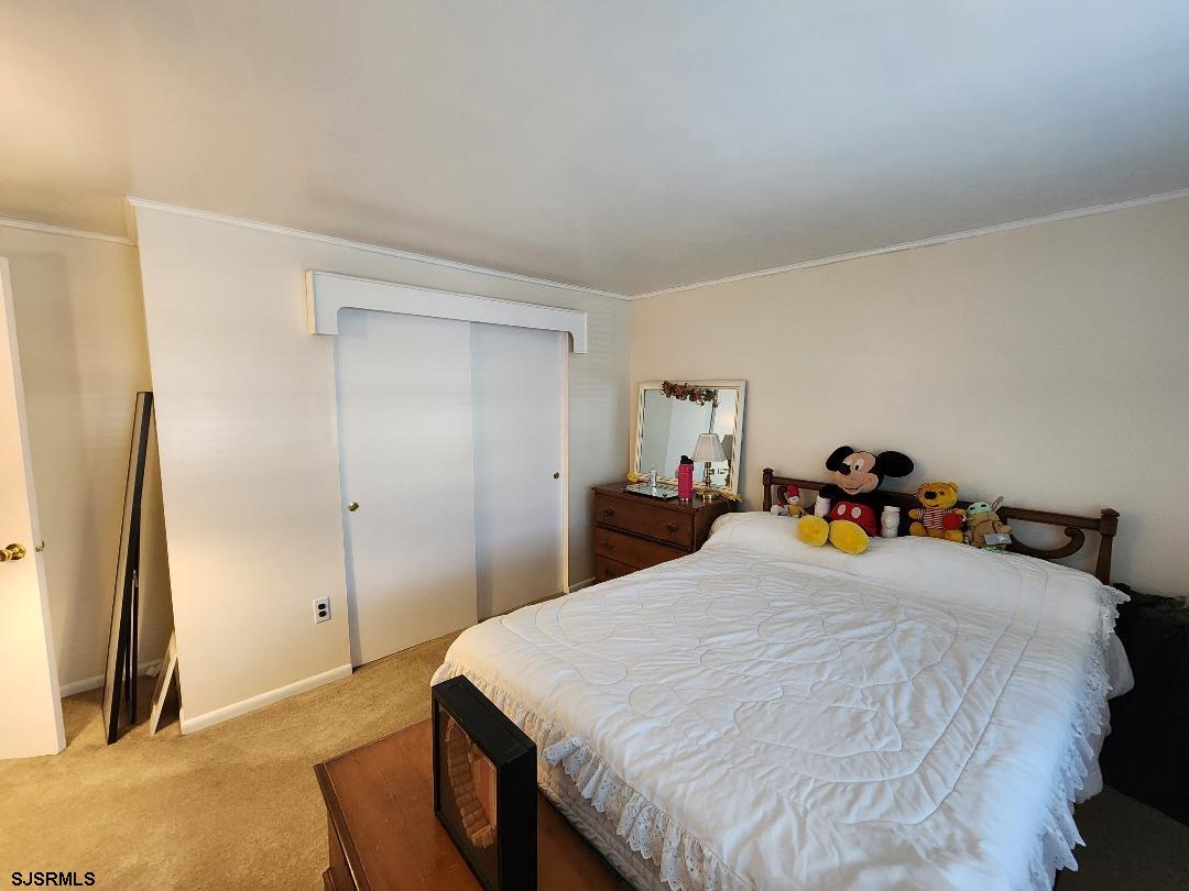 63 Cranford Road Turnersville, NJ 08012 - Photo 29 of 35 a bed room with a bed and a refrigerator