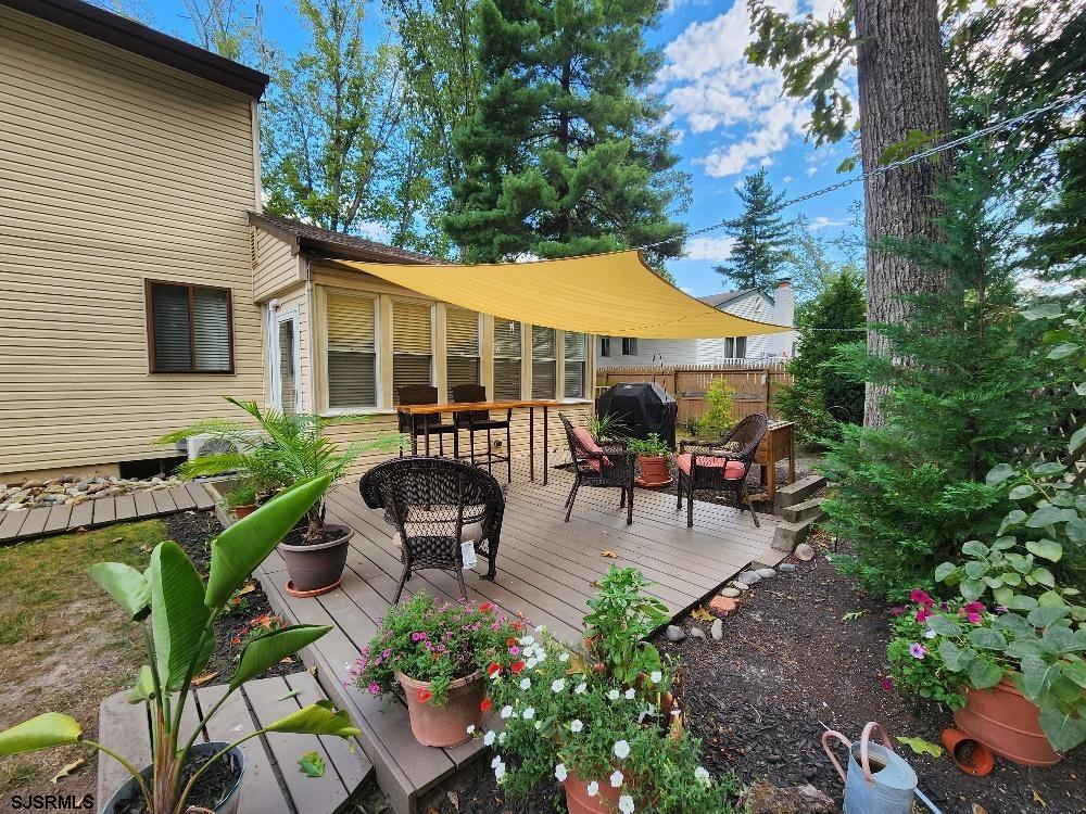63 Cranford Road Turnersville, NJ 08012 - Photo 4 of 35 a view of a patio with table and chairs potted plants and a large tree