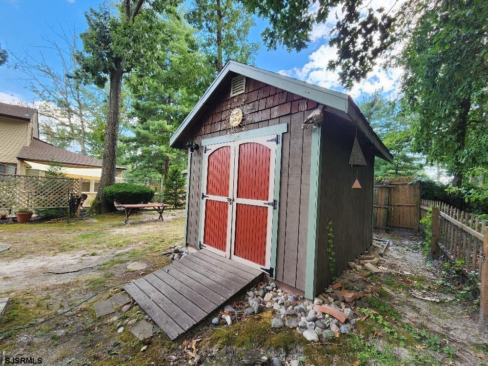 63 Cranford Road Turnersville, NJ 08012 - Photo 10 of 35 a view of a small house in the backyard with large trees and a small yard
