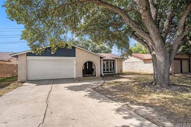 a big house with trees in front of it