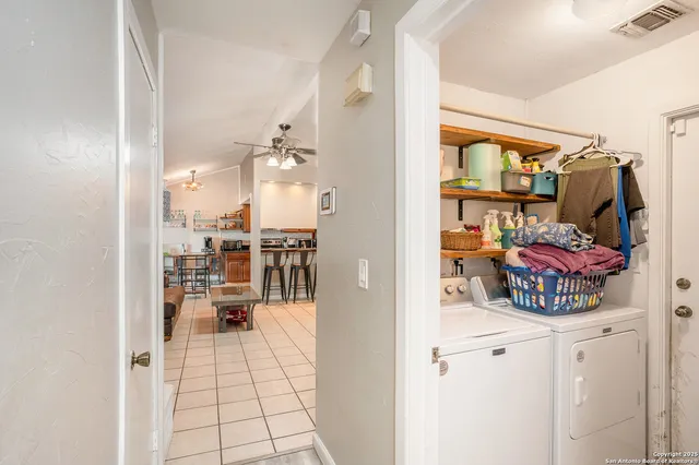 a kitchen with a refrigerator and a stove top oven