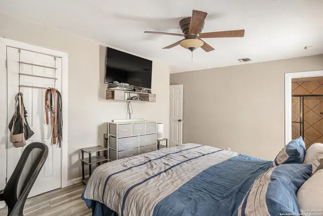 a bedroom with a bed and a flat screen tv