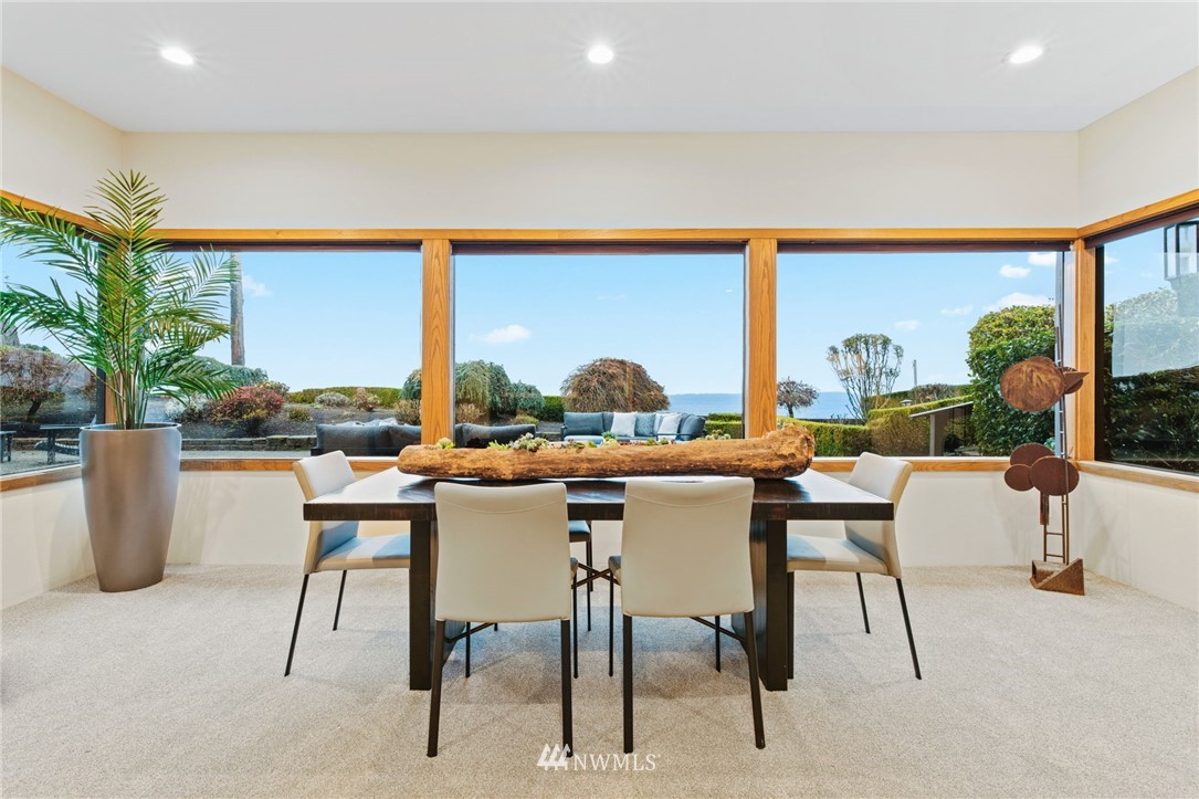 16900 Talbot Road Edmonds, WA 98026 - Photo 30 of 40 a dining room with furniture a floor to ceiling window and a potted plant