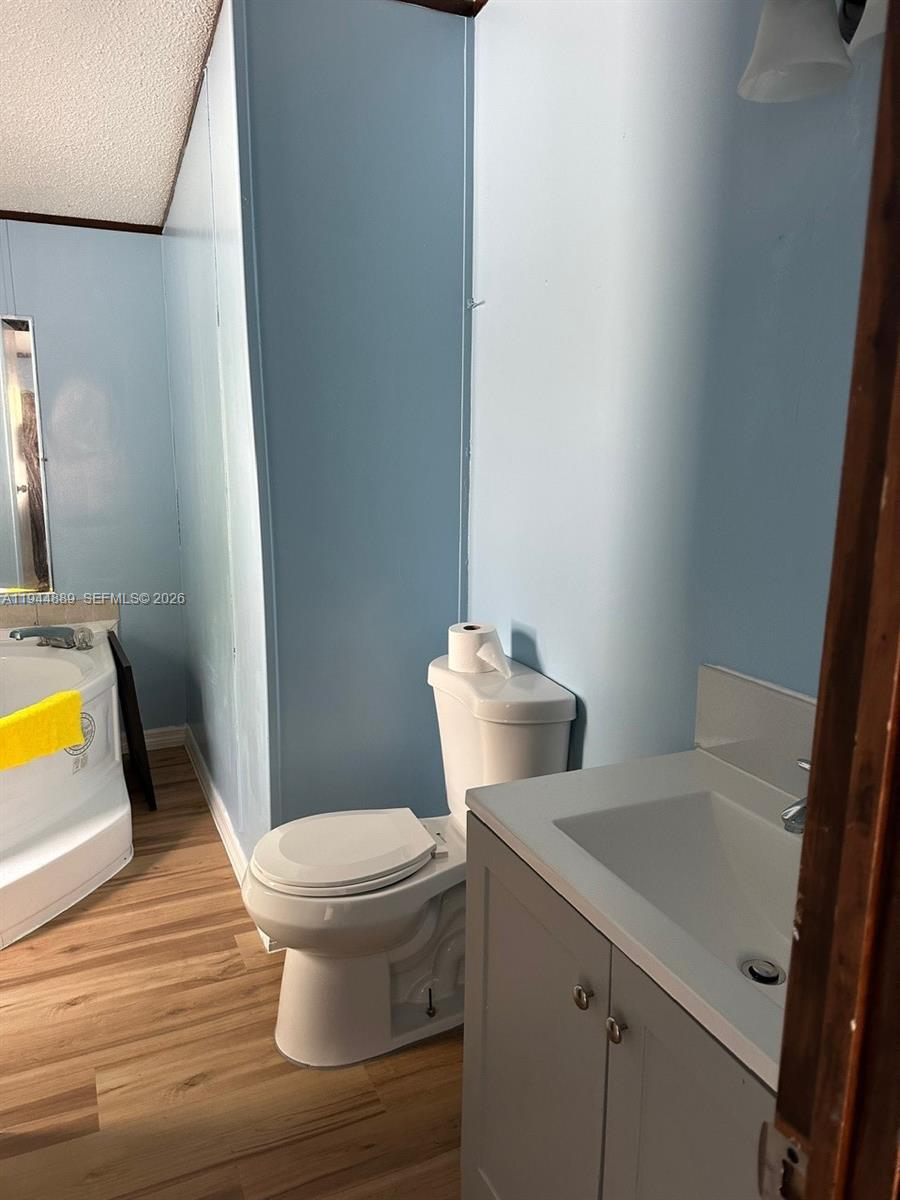 1122 Johnson Road Clewiston, FL 33440 - Photo 11 of 26 a white toilet sitting next to a bathroom sink