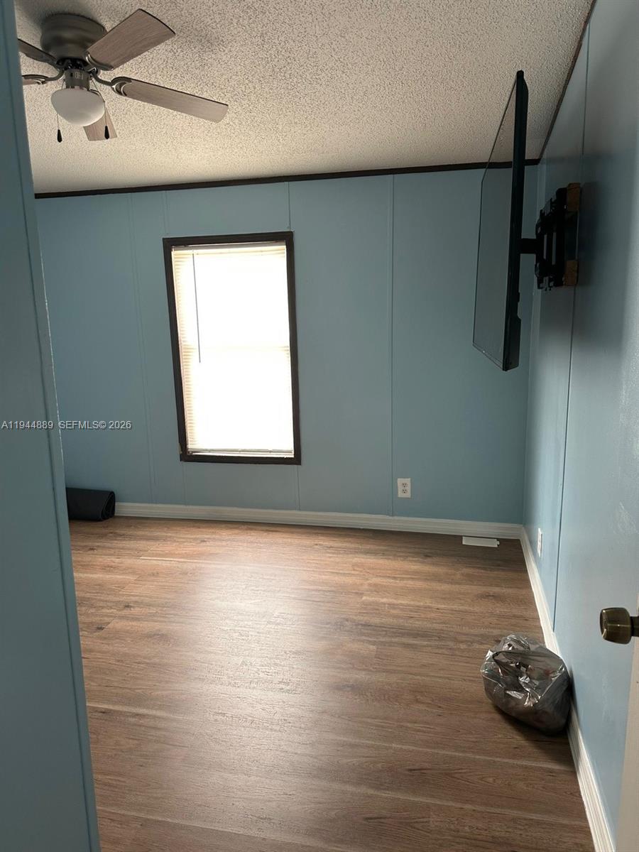 1122 Johnson Road Clewiston, FL 33440 - Photo 14 of 26 a view of a livingroom with wooden floor