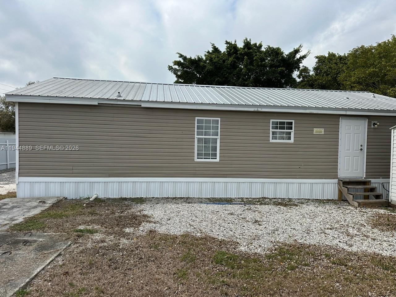 1122 Johnson Road Clewiston, FL 33440 - Photo 19 of 26 a front view of a house with garden