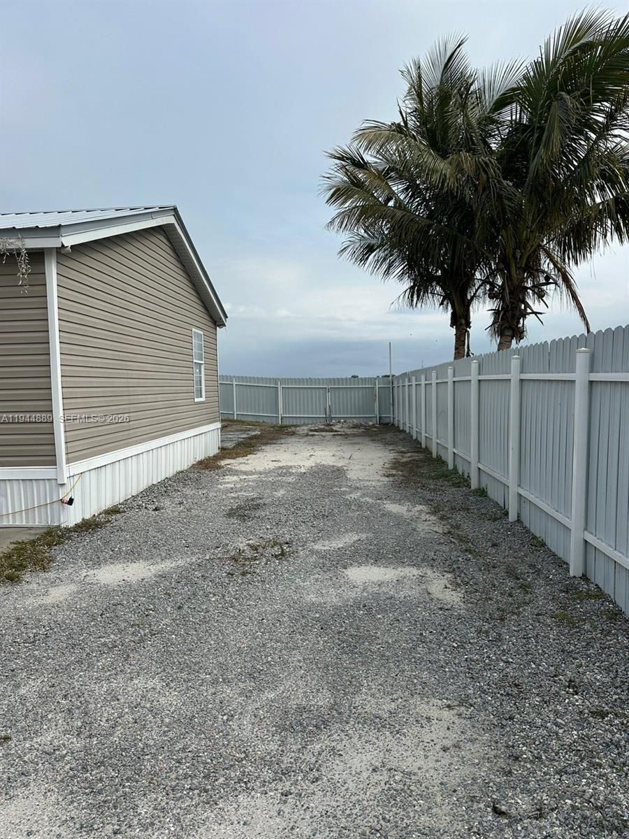 1122 Johnson Road Clewiston, FL 33440 - Photo 21 of 26 a view of a house with a backyard