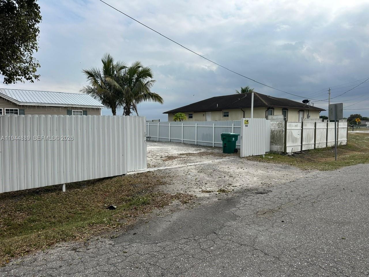1122 Johnson Road Clewiston, FL 33440 - Photo 23 of 26 a view of a house with a yard and garage