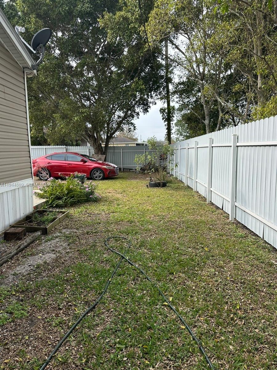 1122 Johnson Road Clewiston, FL 33440 - Photo 25 of 26 a view of a backyard with large trees