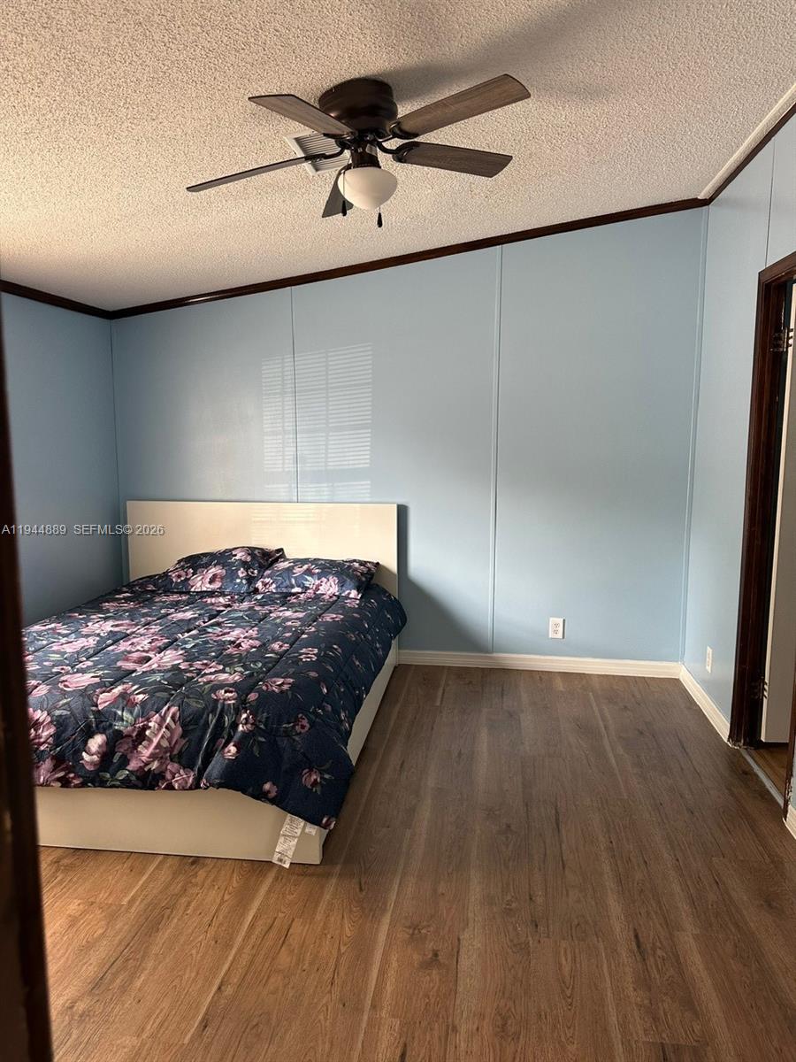 1122 Johnson Road Clewiston, FL 33440 - Photo 8 of 26 a bedroom with a bed and a mirror