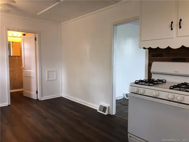 a room with a stove and wooden floor