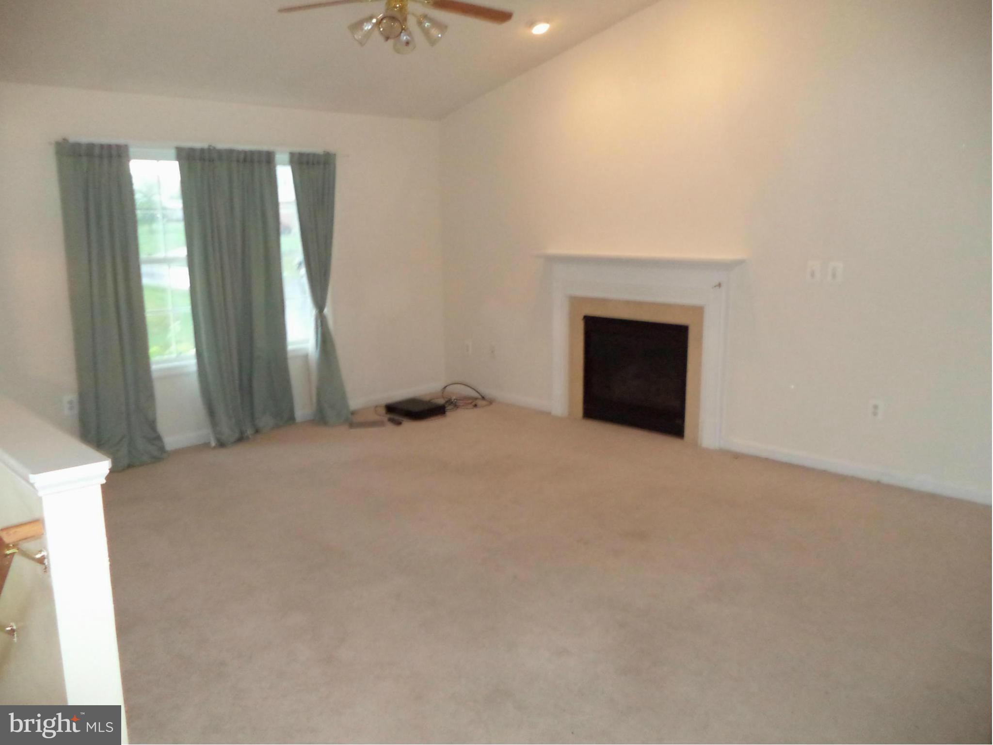 80 Ford Inwood Wv 25428 Inwood, WV 25428 - Photo 9 of 24 an empty room with windows and fireplace
