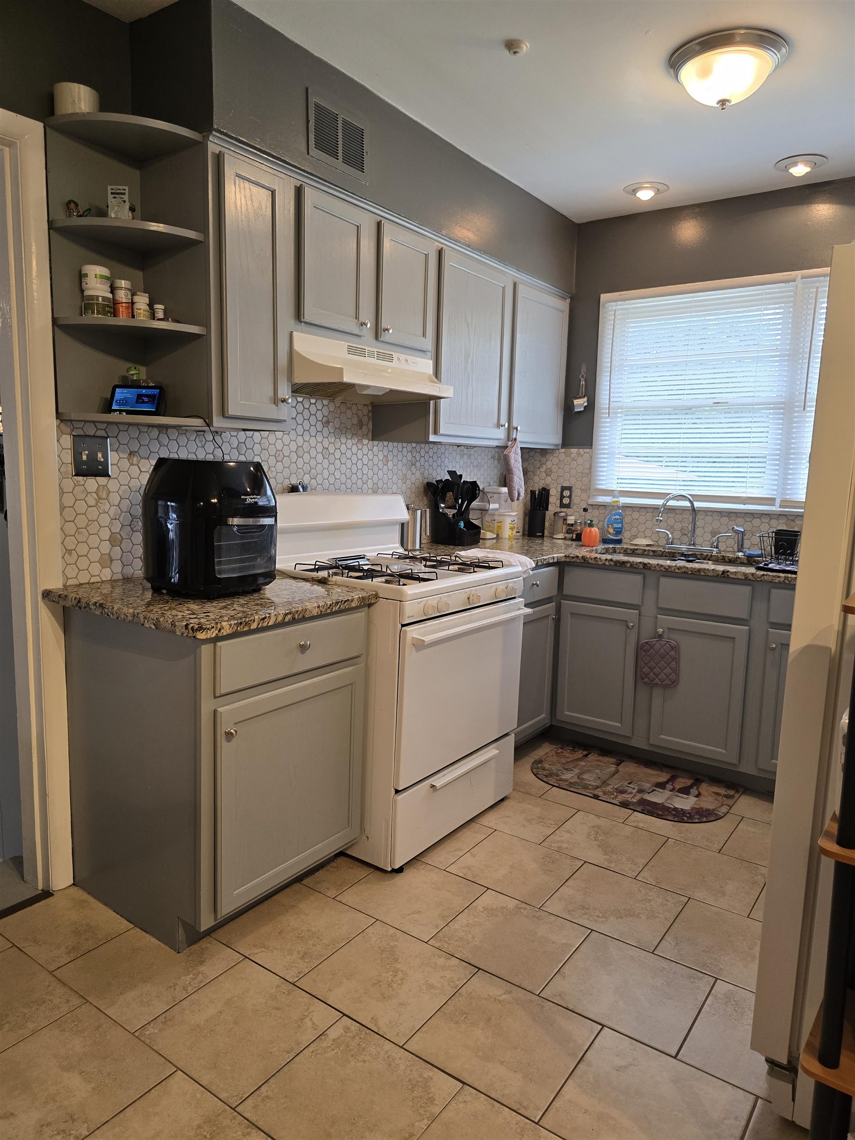 1400 Randall Drive Memphis, TN 38116 - Photo 7 of 23 a kitchen with stainless steel appliances granite countertop a sink and a stove