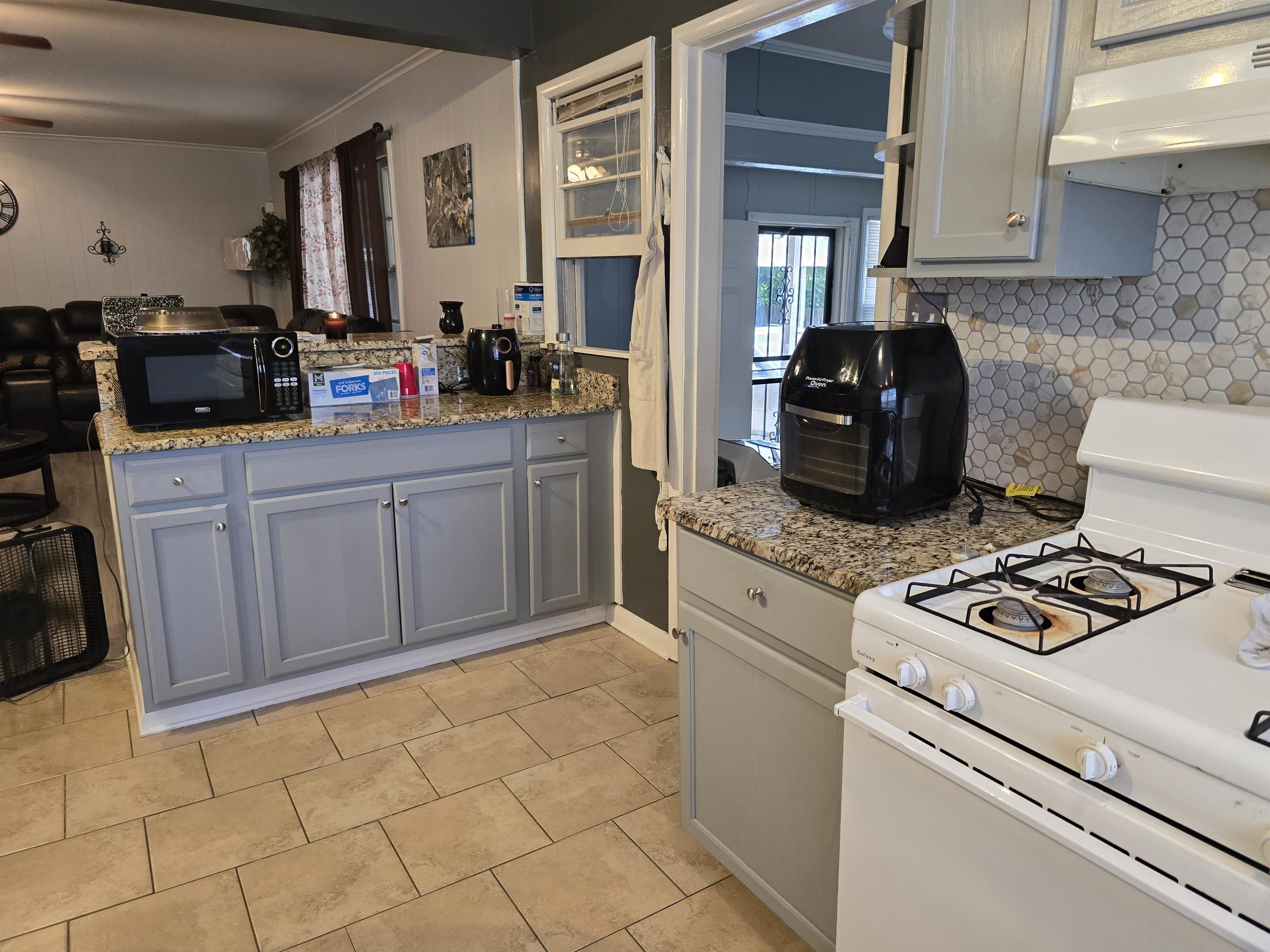 1400 Randall Drive Memphis, TN 38116 - Photo 9 of 23 a kitchen with a stove a sink and a cabinets