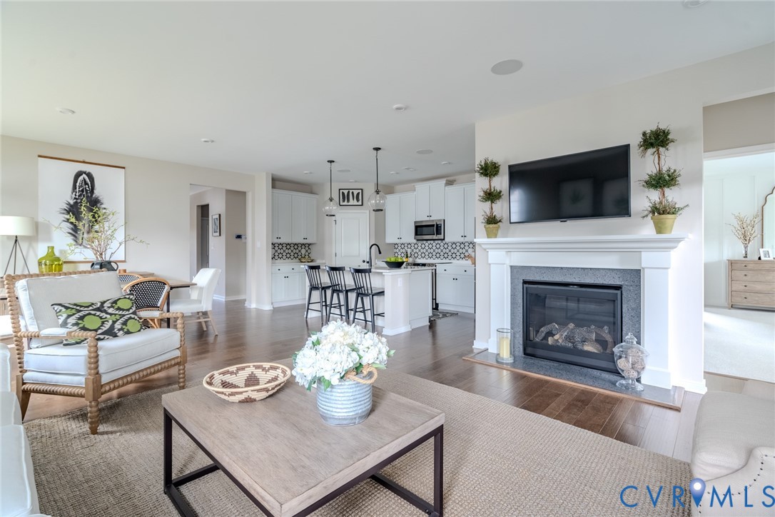 15790 Mosaic Creek Boulevard, Unit 231 Richmond, VA 23238 - Photo 12 of 25 a living room with furniture and a fireplace