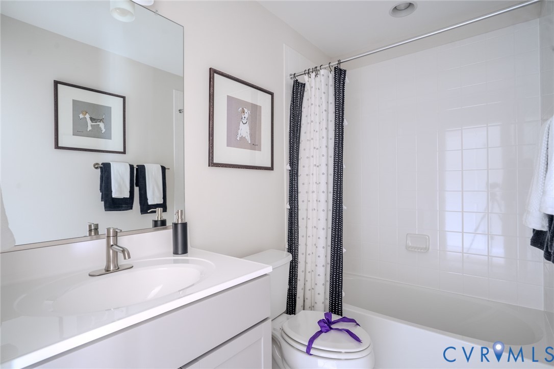 15790 Mosaic Creek Boulevard, Unit 231 Richmond, VA 23238 - Photo 23 of 25 a bathroom with a granite countertop sink a shower and a mirror