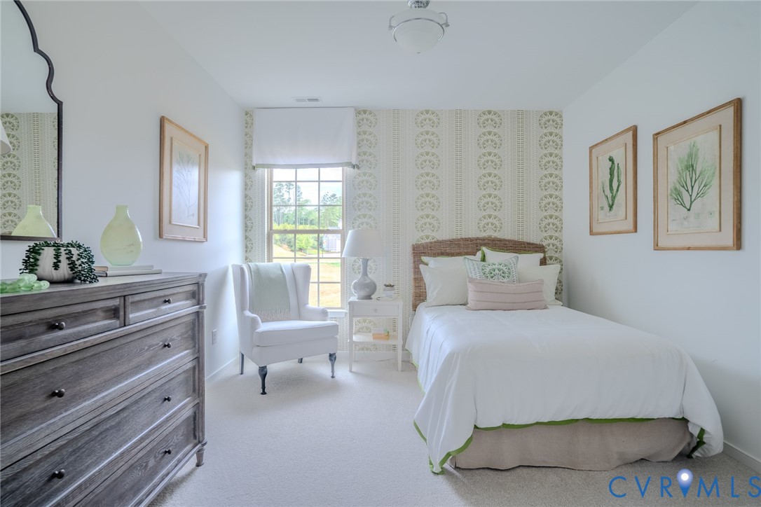 15790 Mosaic Creek Boulevard, Unit 231 Richmond, VA 23238 - Photo 5 of 25 a bedroom with a bed and wooden floor