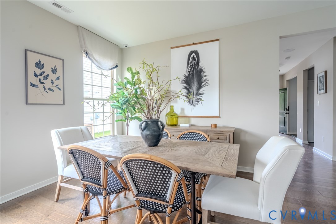 15790 Mosaic Creek Boulevard, Unit 231 Richmond, VA 23238 - Photo 10 of 25 a view of a dining room with furniture window and wooden floor
