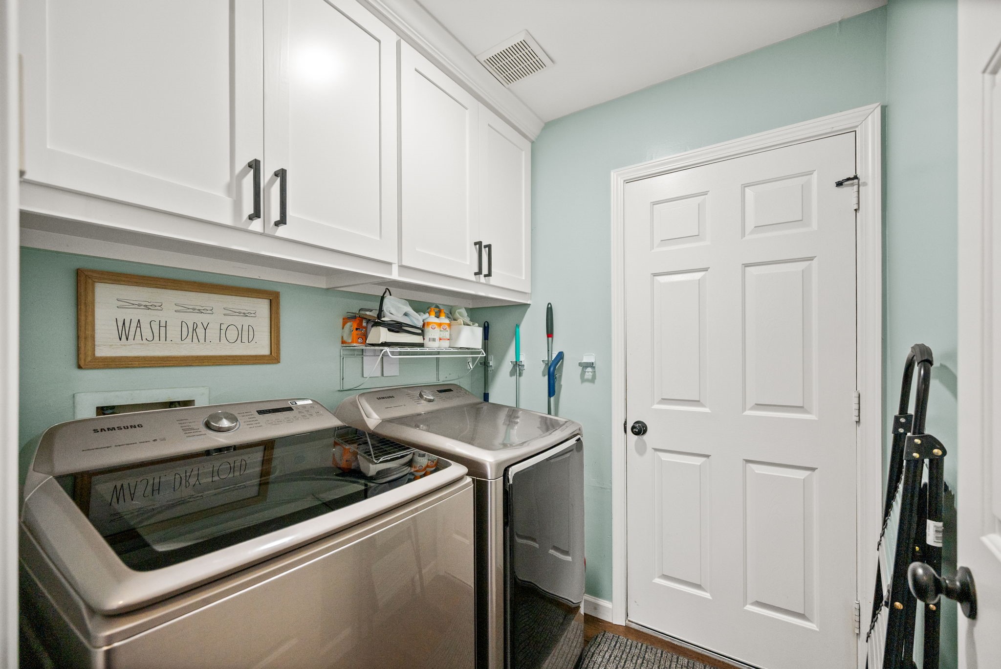 814 Legend Spring Drive Katy, TX 77494 - Photo 24 of 30 The laundry room has built-in storage and direct access to the garage and the kitchen. Even this utilitarian space got the designer touch with a soothing color scheme and the same flooring found throughout the first floor.