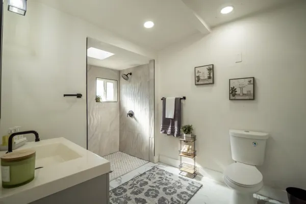 a spacious bathroom with a sink a toilet and shower