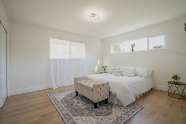 a bedroom with a bed and a couch